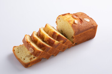 Sliced butter cake on white background