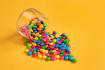 Gems candy on colorful background.