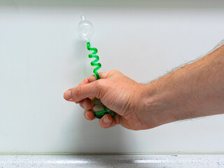 Small device that shows that the green liquid expands when you heat it by hand. Used as a...