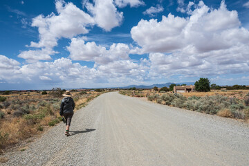 Usa, New Mexico, Santa Fe, Rear view of woman walking rural road