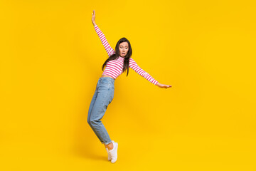 Full length photo of astonished worried lady stay toes fall down look empty space isolated on yellow color background