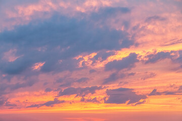 orange gold sunset ,dramatic fluffy clouds at pink evening sky nature landscape