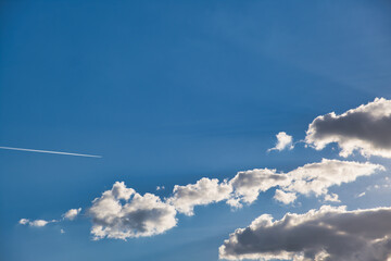 blue sky with cloud formations sun rays, background photo