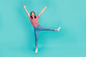 Fototapeta premium Full length photo of adorable funny girl dressed red t-shirt smiling having fun dancing isolated teal color background