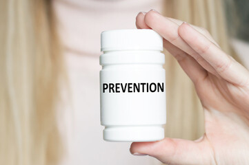 Prevention inscription on a white can in the hands of a doctor close-up