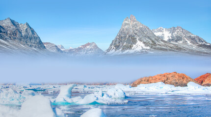 Arctic landscape of Greenland in Summer. Beautiful view of mountains with Snowy peaks and iceberg
