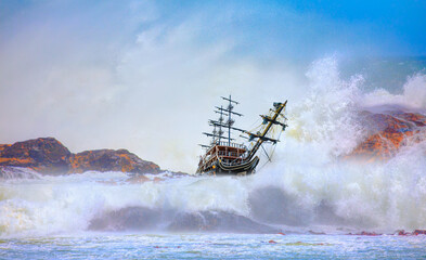 An old sailing ship that crashed into a cliff and strong sea wave - Shipwrecked off the coast - An...