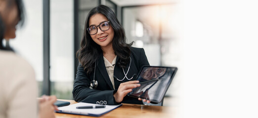 Young female medical doctor and patient in the hospital. Medical consultation.