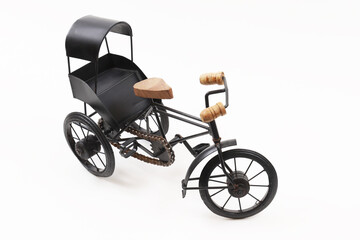 Fototapeta na wymiar Decorative souvenir bike. Antique tricycle-carriage. Shallow depth of field