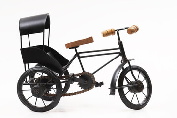 Decorative souvenir bike. Antique tricycle-carriage. Shallow depth of field