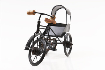 Fototapeta premium Decorative souvenir bike. Antique tricycle-carriage. Shallow depth of field