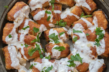 Traditional Bosnian pastry with minced meat (minced meat) isolated on wooden background. Turkish name; Bosnian dumplings.