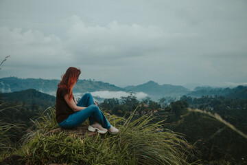 young woman sits on little adam's peak