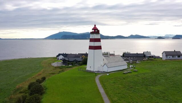 Flying above the iconic Alnes Lighthouse on a cloudy day, Aerial Orbit