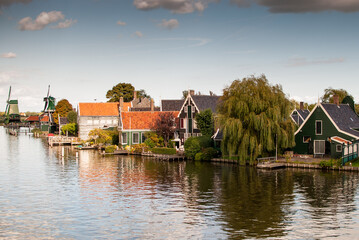 casas al borde del agua con reflejos y cielo azul en el típico y turístico pueblo De Zaanse Schans en holanda, países bajos.