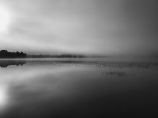Morning fog over the lake in black and white with space for text