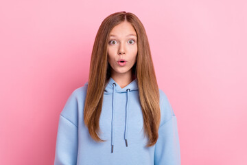 Photo of young pretty funny face brown hair schoolgirl kid wear blue hoodie positive pouted lips reaction unexpected isolated on bright pink color background