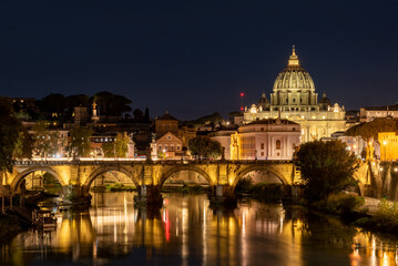 Fototapeta premium Panoramic View of the Dome of the Basilic of Saint Peter in Rome beside the Bridge on the Tevere River in Rome at Sunset