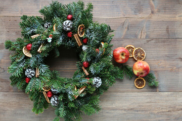 Fototapeta na wymiar Big traditional Christmas wreath on wooden background, copy space.