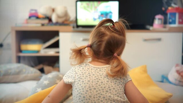 Little Girl Watching Television. Appropriate Content For Kids. Early Age Education. Happy Cute Little Kid Watching Cartoon. Little Girl Sitting On Bed Watching Television. Child On Happy Time Cartoon