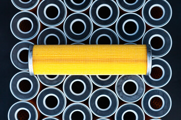 New yellow machine filters, stacked to each other and one filter on top of them.