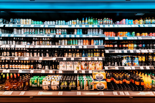 24 July 2022, Osnabruck, Germany: An assortment of soft and light alcoholic beverages in the refrigerator in the supermarket. Consumer economics and business