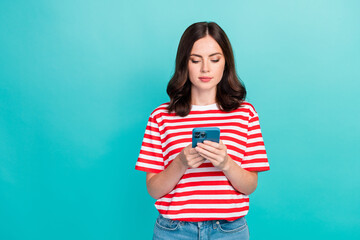 Fototapeta premium Photo of pretty cute lady wear striped t-shirt chatting instagram twitter facebook modern device isolated turquoise color background
