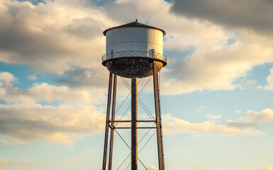 Water tower with cloudy sky