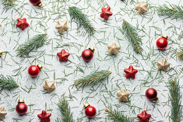 Creative Christmas background with Christmas balls, pine twigs, red and golden stars decorations on white background. Flat lay, top view, copy space