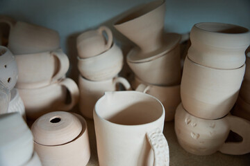 Small pottery items stand on a shelf