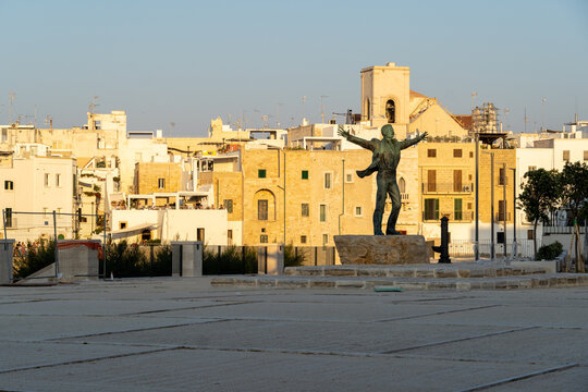 Bari, Puglia, Italy. Jul 2022: Statue of Domenico Modugno at Polignano a Mare at sunset. -