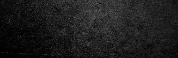 Panoramic black and grey concrete texture background. Scary dark walls, slightly light black...