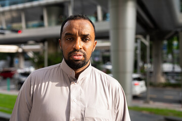Naklejka premium Portrait of handsome black man in city wearing traditional clothes