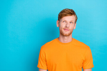 Photo of thoughtful handsome guy with ginger hairstyle dressed yellow t-shirt look empty space...