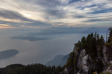 Canadian Mountain Landscape on the West Coast of Pacific Ocean. Dramatic Sunset and Hazy Smoky Sky. St. Mark's Summit near Vancouver, British Columbia, Canada. Nature Background