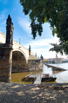 Look over Vltava river to Charles Bridge from embankment in autumn. Prague, Czech Republic.