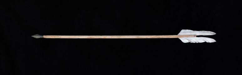 ancient wooden arrow on black background