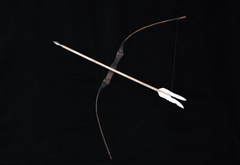 wooden hunting bow on a black background