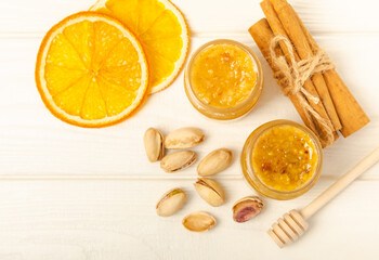 Nut honey jar on white wood. Cold medicine. Useful fortified product with almonds, pistachios, star anise and cinnamon for health and beauty. Vegetarian diet organic product. Copy space.place for text