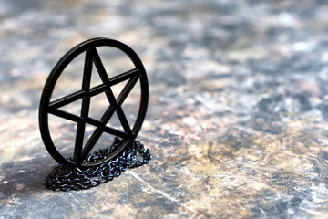 Pentagram necklace on dark grungy background