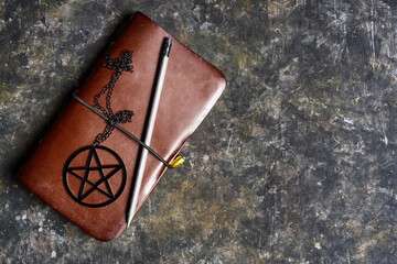Leather journal and black pentagram necklace