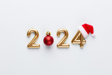 New year 2024 number, golden digits and santa hat over blue background.