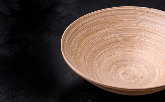 An Empty Wooden Brown Fruit Bowl On A Dark Concrete Background