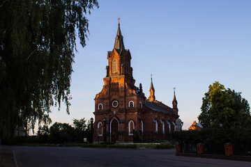 Vladimir, Russia, August, 17, 2022: Brick Catholic Church of the Holy Rosary of the Blessed Virgin Mary in the historical center on a sunny summer day among green trees