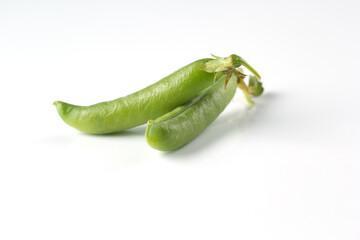 Pea pods on a white background, green peas in a pod