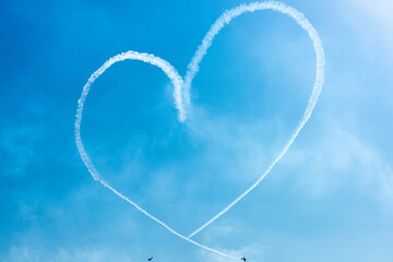 Two Light Airplanes In The Sky Writing Romantic Heart Shape - obrazy, fototapety, plakaty