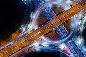 Expressway top view, Road traffic an important infrastructure, car traffic transportation above intersection road in city night, aerial view cityscape of advanced innovation, financial technology	