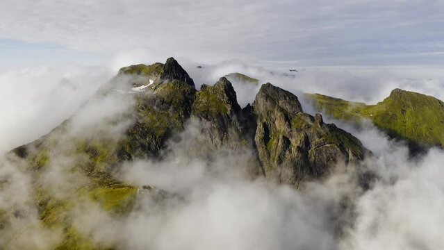 Aerial View of Sunset and Floating Clouds Above the Green Norway Lofoten Islands and Mountains.