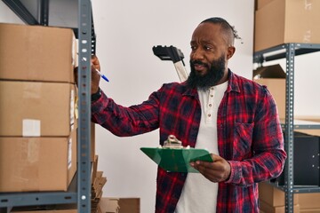 Young african american man ecommerce business worker organizing packages at office