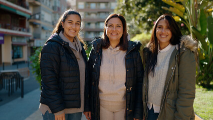 Mother and daugthers smiling confident standing together at park